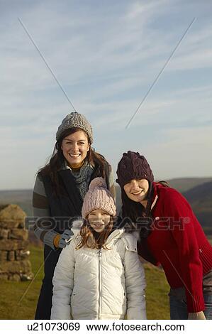 Mother and daughters smiling outdoors View Large Photo Image Stock Photo - Mother and daughters smiling outdoors. Fotosearch