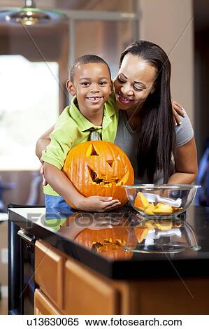 Mother and son carving jack-o-lantern View Large Photo Image Stock Photography - Mother and son carving jack-o-lantern. Fotosearch
