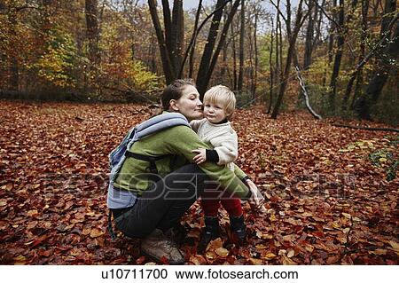 Mother and son in autumn leaves View Large Photo Image Stock Image - Mother and son in autumn leaves. Fotosearch