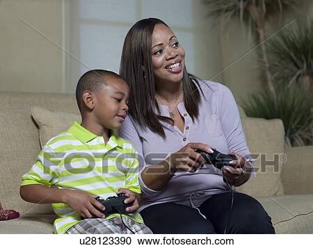 Mother and son playing video games View Large Photo Image Stock Image - Mother and son playing video games. Fotosearch
