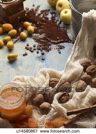 Stock Photo - Nuts, jam, coffee and fruit on table. Fotosearch
