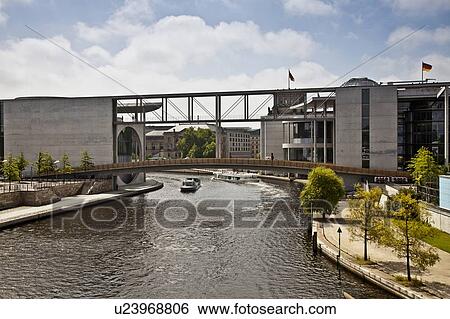 Stock Photograph - Pedestrian bridge over urban canal. Fotosearch
