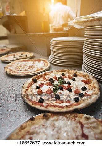 Pizzas on counter in kitchen View Large Photo Image Stock Photo - Pizzas on counter in kitchen. Fotosearch