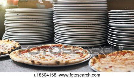 Pizzas on counter in kitchen View Large Photo Image Stock Photo - Pizzas on counter in kitchen. Fotosearch