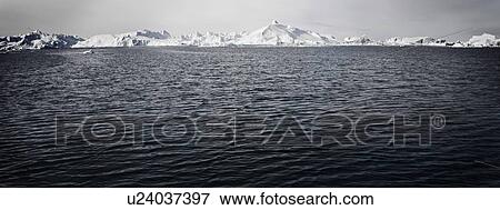 Stock Photo - Rippling lake in snowy landscape. Fotosearch