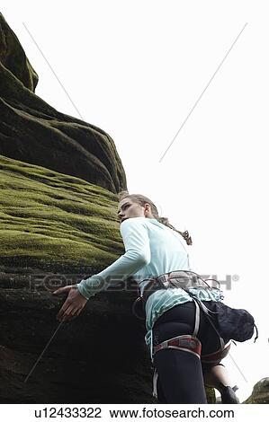 Rock climber scaling boulder View Large Photo Image Stock Image - Rock climber scaling boulder. Fotosearch