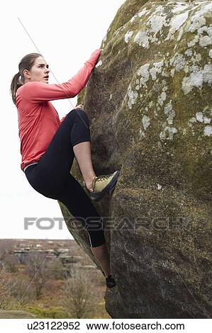Rock climber scaling boulder View Large Photo Image Stock Image - Rock climber scaling boulder. Fotosearch