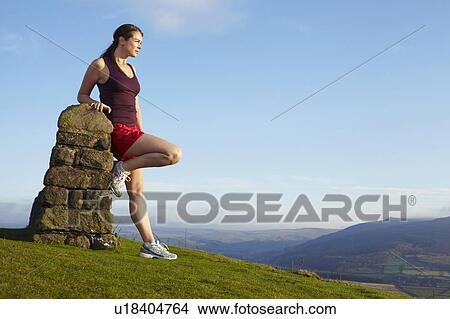 Runner leaning against rock wall View Large Photo Image Picture - Runner leaning against rock wall. Fotosearch