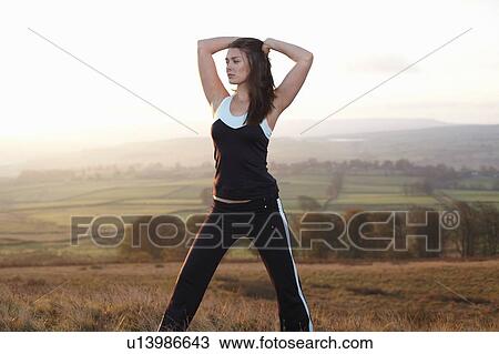 Runner stretching in rural landscape View Large Photo Image Stock Image - Runner stretching in rural landscape. Fotosearch
