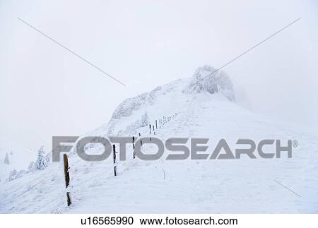 Stock Image - Rural fence obscured by snow. Fotosearch