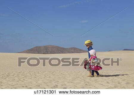 Siblings walking together on beach View Large Photo Image Stock Image - Siblings walking together on beach. Fotosearch