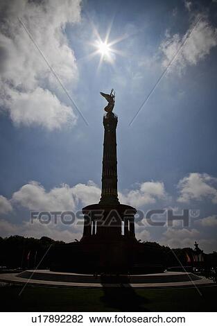 Stock Image - Silhouette of ornate tower in courtyard. Fotosearch