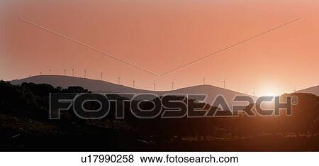 Silhouette of windmills on rural hills View Large Photo Image Stock Photo - Silhouette of windmills on rural hills. Fotosearch