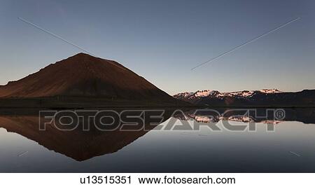 Stock Image - Sky reflected in lake in rural landscape. Fotosearch
