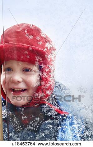 Smiling boy looking in frosty window View Large Photo Image Picture - Smiling boy looking in frosty window. Fotosearch