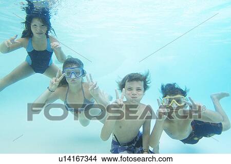 Smiling children playing in pool View Large Photo Image Picture - Smiling children playing in pool. Fotosearch