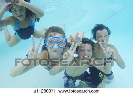 Smiling children playing in pool View Large Photo Image Stock Image - Smiling children playing in pool. Fotosearch