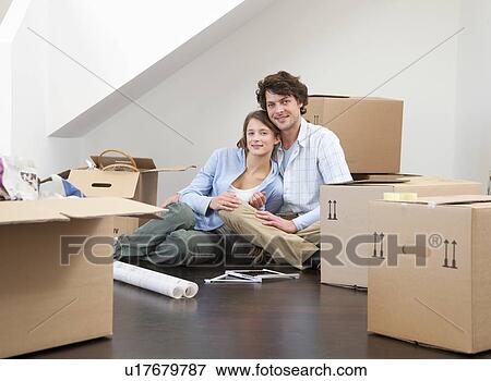 Smiling couple with cardboard boxes View Large Photo Image Stock Photo - Smiling couple with cardboard boxes. Fotosearch