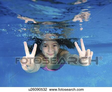 Smiling girl playing in swimming pool View Large Photo Image Stock Image - Smiling girl playing in swimming pool. Fotosearch