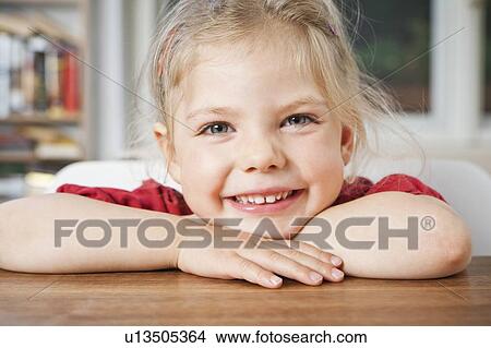 Picture - Smiling girl resting on elbows. Fotosearch