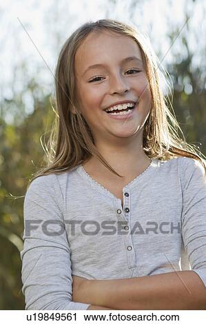 Smiling girl standing outdoors View Large Photo Image Stock Image - Smiling girl standing outdoors. Fotosearch