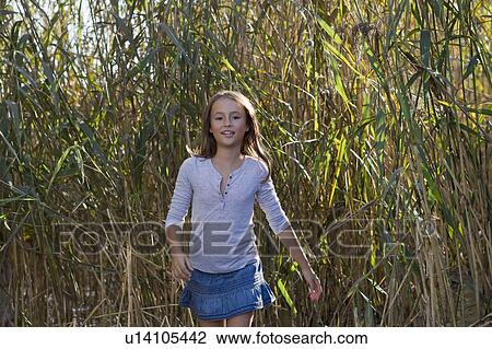 Smiling girl walking in wheatfield View Large Photo Image Stock Image - Smiling girl walking in wheatfield. Fotosearch