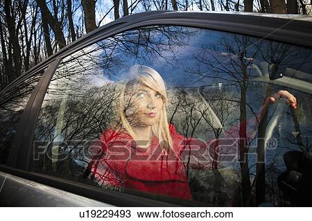 Smiling woman driving in woods View Large Photo Image Stock Image - Smiling woman driving in woods. Fotosearch