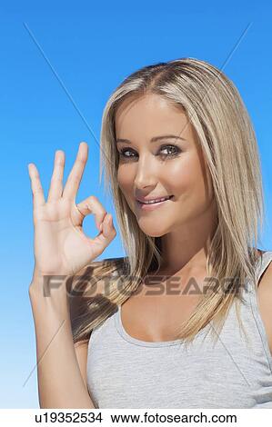 Smiling woman making OK sign View Large Photo Image Picture - Smiling woman making OK sign. Fotosearch