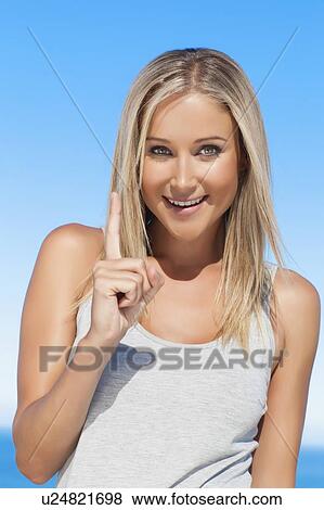Smiling woman pointing outdoors View Large Photo Image Stock Photo - Smiling woman pointing outdoors. Fotosearch