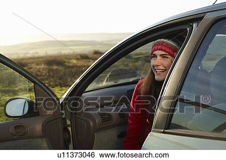 Smiling woman sitting in car View Large Photo Image Stock Photograph - Smiling woman sitting in car. Fotosearch
