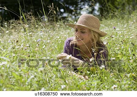Smiling woman sitting in wheatfield View Large Photo Image Stock Image - Smiling woman sitting in wheatfield. Fotosearch