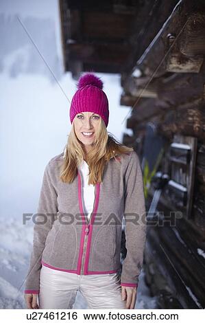 Smiling woman standing in snow View Large Photo Image Stock Photograph - Smiling woman standing in snow. Fotosearch