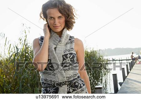 Smiling woman standing on pier View Large Photo Image Stock Image - Smiling woman standing on pier. Fotosearch