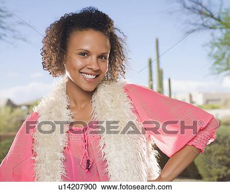 Smiling woman standing outdoors View Large Photo Image Stock Image - Smiling woman standing outdoors. Fotosearch