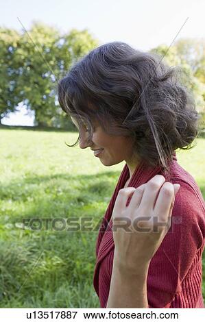 Smiling woman walking outdoors View Large Photo Image Stock Photo - Smiling woman walking outdoors. Fotosearch