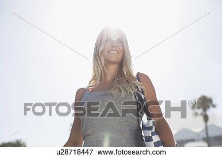 Smiling woman walking outdoors View Large Photo Image Stock Photo - Smiling woman walking outdoors. Fotosearch