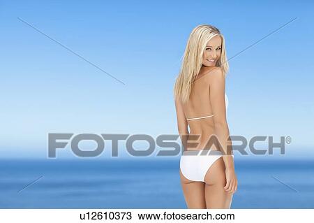 Smiling woman wearing bikini outdoors View Large Photo Image Stock Image - Smiling woman wearing bikini outdoors. Fotosearch