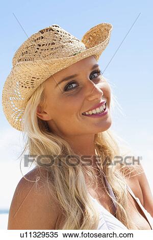 Smiling woman wearing sunhat outdoors View Large Photo Image Stock Photography - Smiling woman wearing sunhat outdoors. Fotosearch
