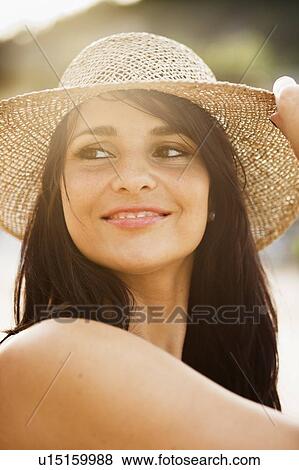 Stock Photo - Smiling woman wearing sunhat. Fotosearch
