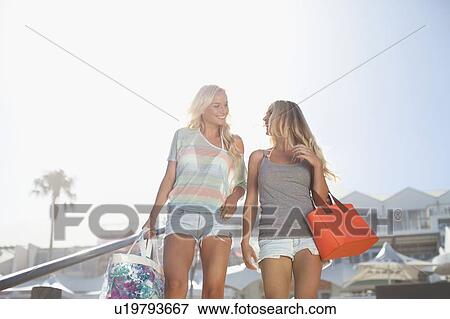 Stock Photo - Smiling women walking on steps. Fotosearch