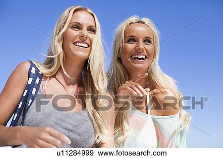 Smiling women walking together outdoors View Large Photo Image Stock Photo - Smiling women walking together outdoors. Fotosearch