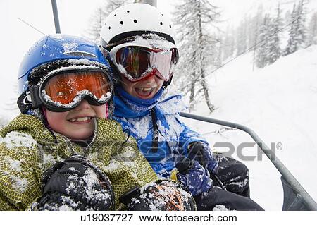 Stock Photo - Snow-covered children in ski lift . Fotosearch