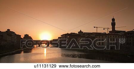 Sun setting over urban bridge View Large Photo Image Stock Photo - Sun setting over urban bridge. Fotosearch