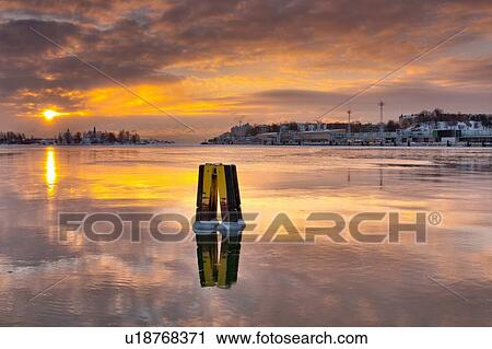 Sun setting over urban pier View Large Photo Image Stock Image - Sun setting over urban pier. Fotosearch