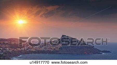 Sun setting over village on hillside View Large Photo Image Stock Image - Sun setting over village on hillside. Fotosearch