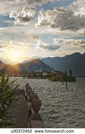 Sun shining over coastline village View Large Photo Image Stock Image - Sun shining over coastline village. Fotosearch