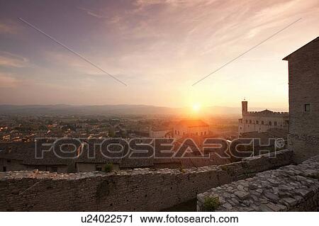 Stock Image - Sun shining over stone city walls. Fotosearch