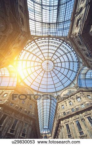 Stock Image - Sun shining through ornate glass ceiling. Fotosearch