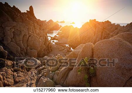 Sun shining through rock formations View Large Photo Image Stock Image - Sun shining through rock formations. Fotosearch