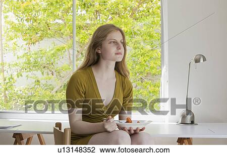 Teenage girl eating in kitchen View Large Photo Image Stock Image - Teenage girl eating in kitchen. Fotosearch